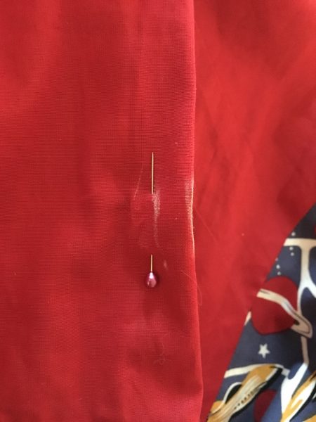 Then I took out the pin so that I could re-insert it on the interior. I folded it over at the edge mark and inserted a pin at the same spot it was located before. I’ve basically created the same pinch as before, only now it’s inside the dress instead of on the outer side.