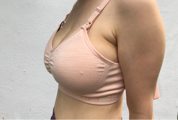 Side view showing the bra overly compressing the breasts